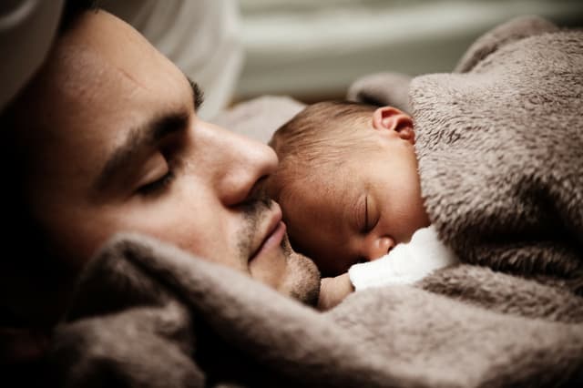 baby sleeping on dads chest