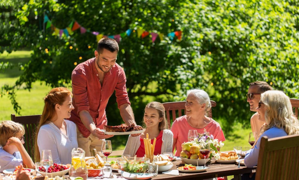 a family gathering at table outside with food indicating a safe environment for adoption conversations with family in Corpus Christi