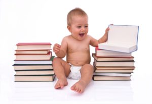 baby surrounded with books about adoption