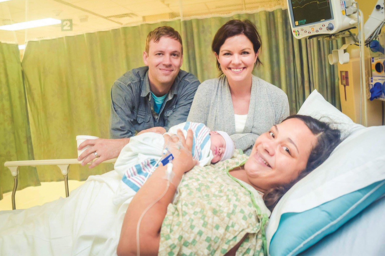 Birthmom and adoptive parents with their baby in an open adoption