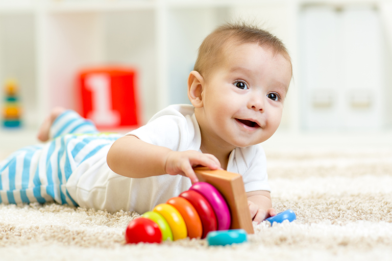 Adopted baby playing with toys in his home