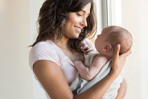 Single parent holding baby they adopted