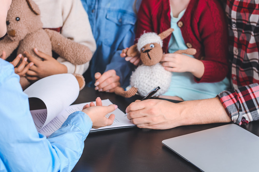 ocial worker meeting with couple for signing adoption documents