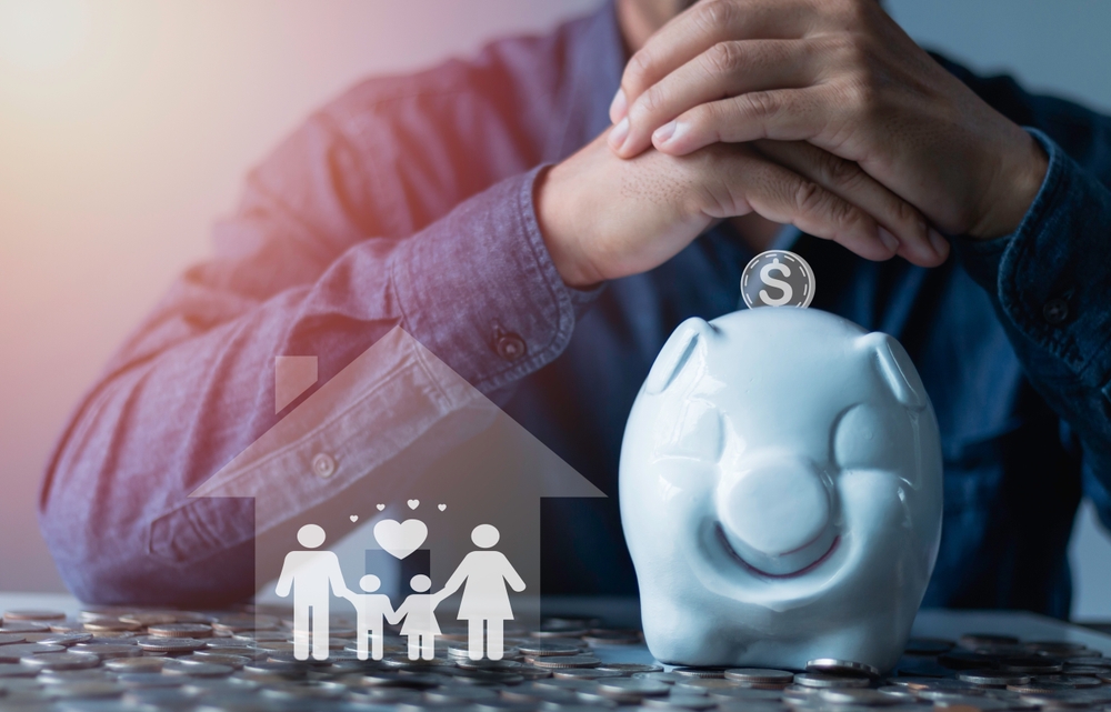 Family finance plan concept, Businessman takes a position to protect the piggybank and family in hand, saving, donation, charity, fundraising, superannuation, and financial crisis concep