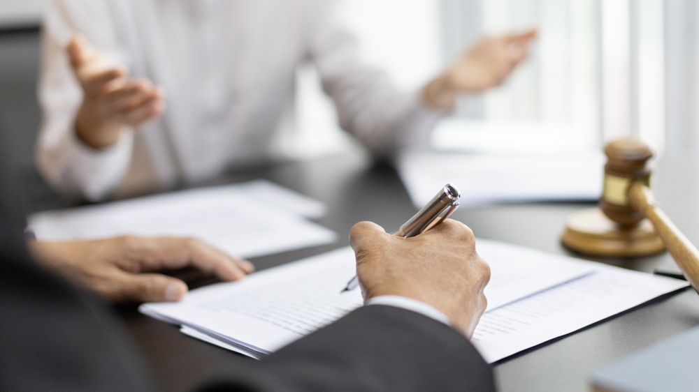 Client describes the money fraud problem and discusses the solution with a lawyer in the litigation room, Ethics in the courts include justice, legal consultant, Scales of justice, Litigation.