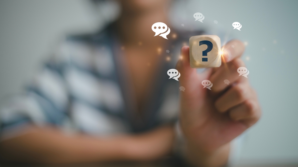 Businesswoman using question marks with speech bubbles.Q and A. Online service gives quick answers