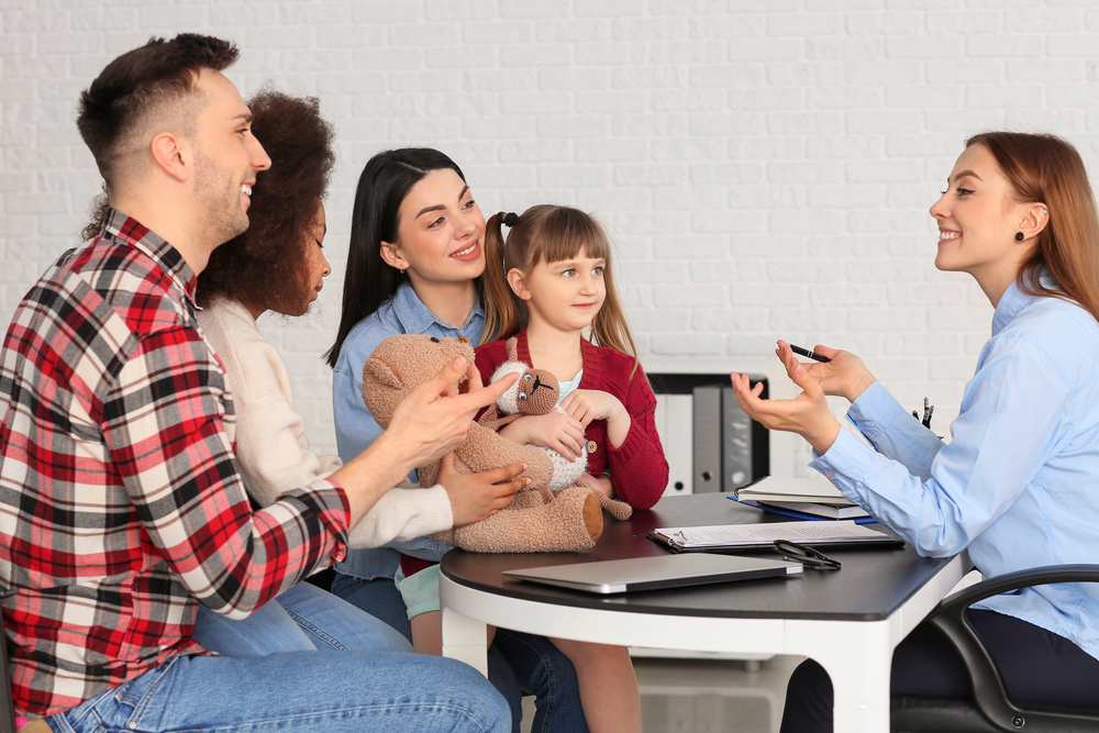 Social worker meeting with couple for signing adoption documents