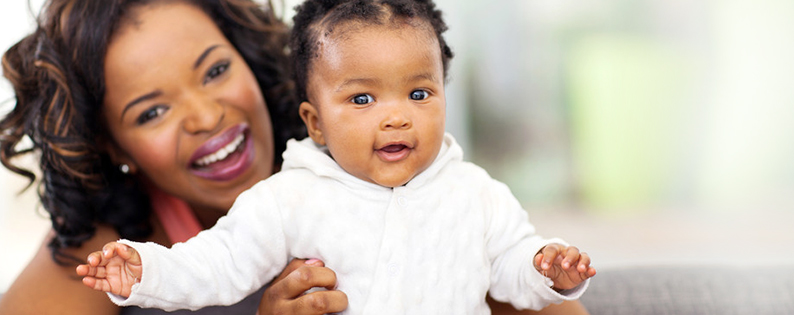 smiling adoptive mom holding her baby girl