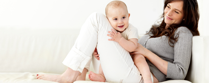 adoptive mom on couch with baby on her lap