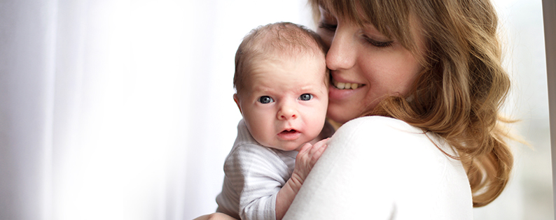adoptive mom cuddling baby boy