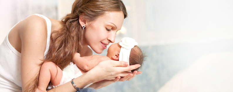 adoptive mom cuddling with newborn baby