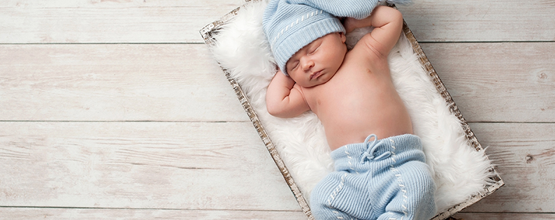 baby boy sleeping in a basket