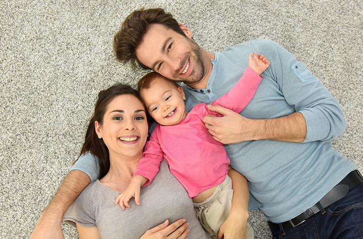 smiling adoptive parents holding their baby