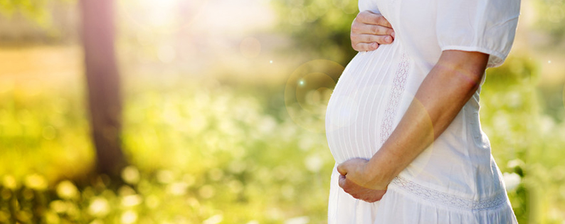 pregnant woman in a white dress