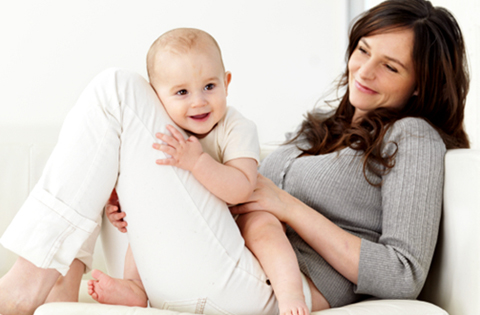 adoptive mom on couch with baby on her lap