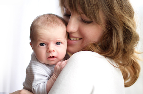 adoptive mom cuddling baby boy