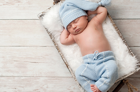 baby boy sleeping in a basket