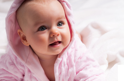 baby girl wrapped in pink