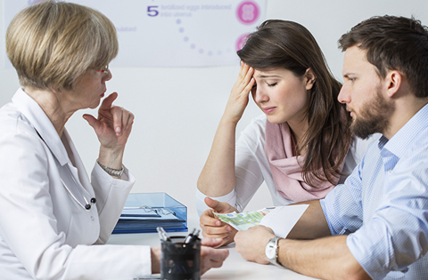 couple facing infertility talking with a doctor