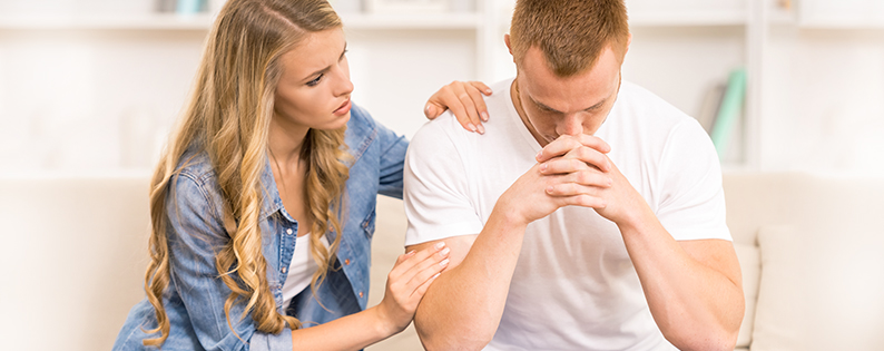 wife comforting husband struggling with adoption